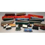 A collection of OO gauge goods wagons and coaches, some boxed