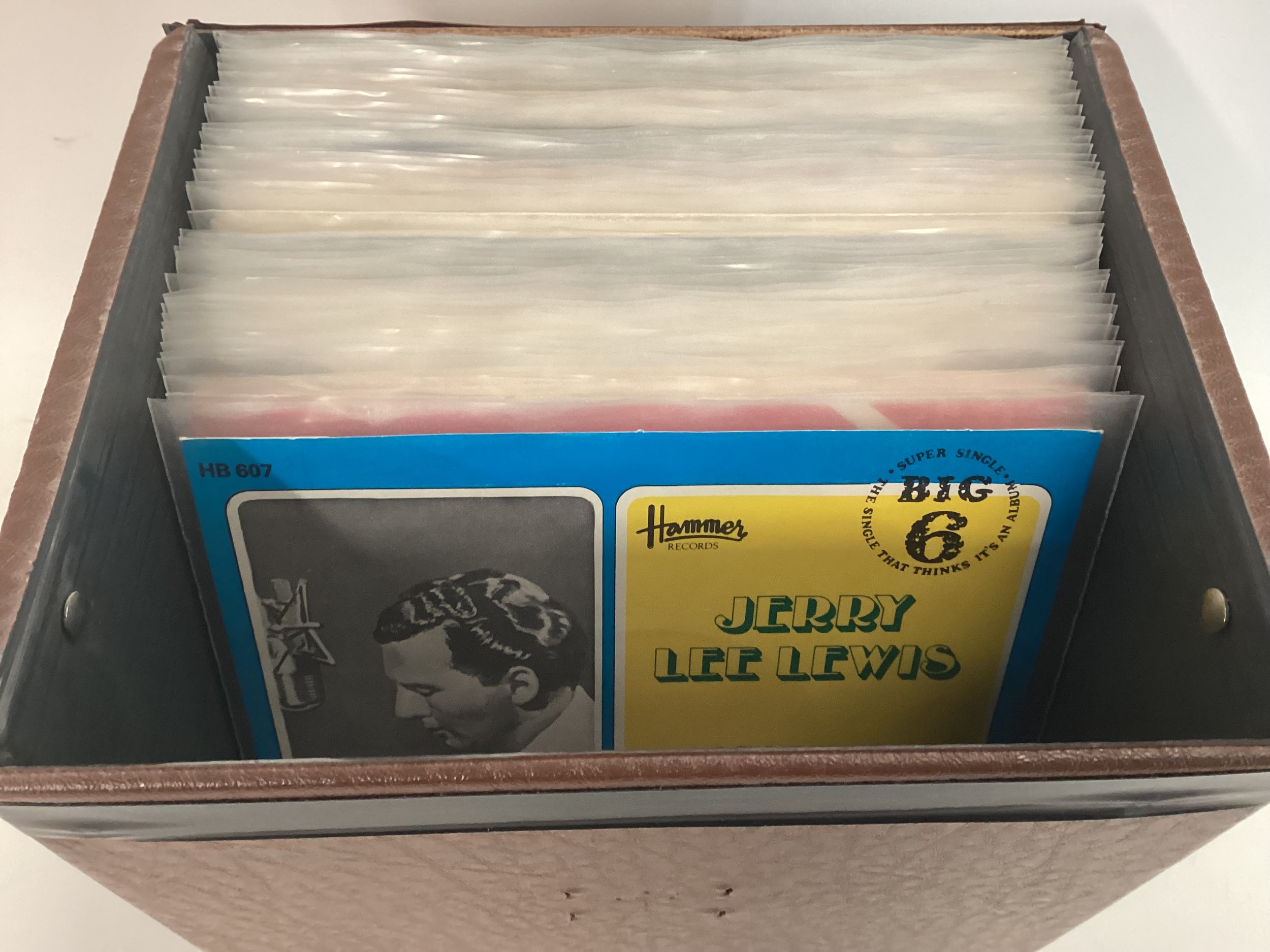 CASE OF VARIOUS HIT SINGLES. This is a collection of 45rpm records which include a lot of reissued
