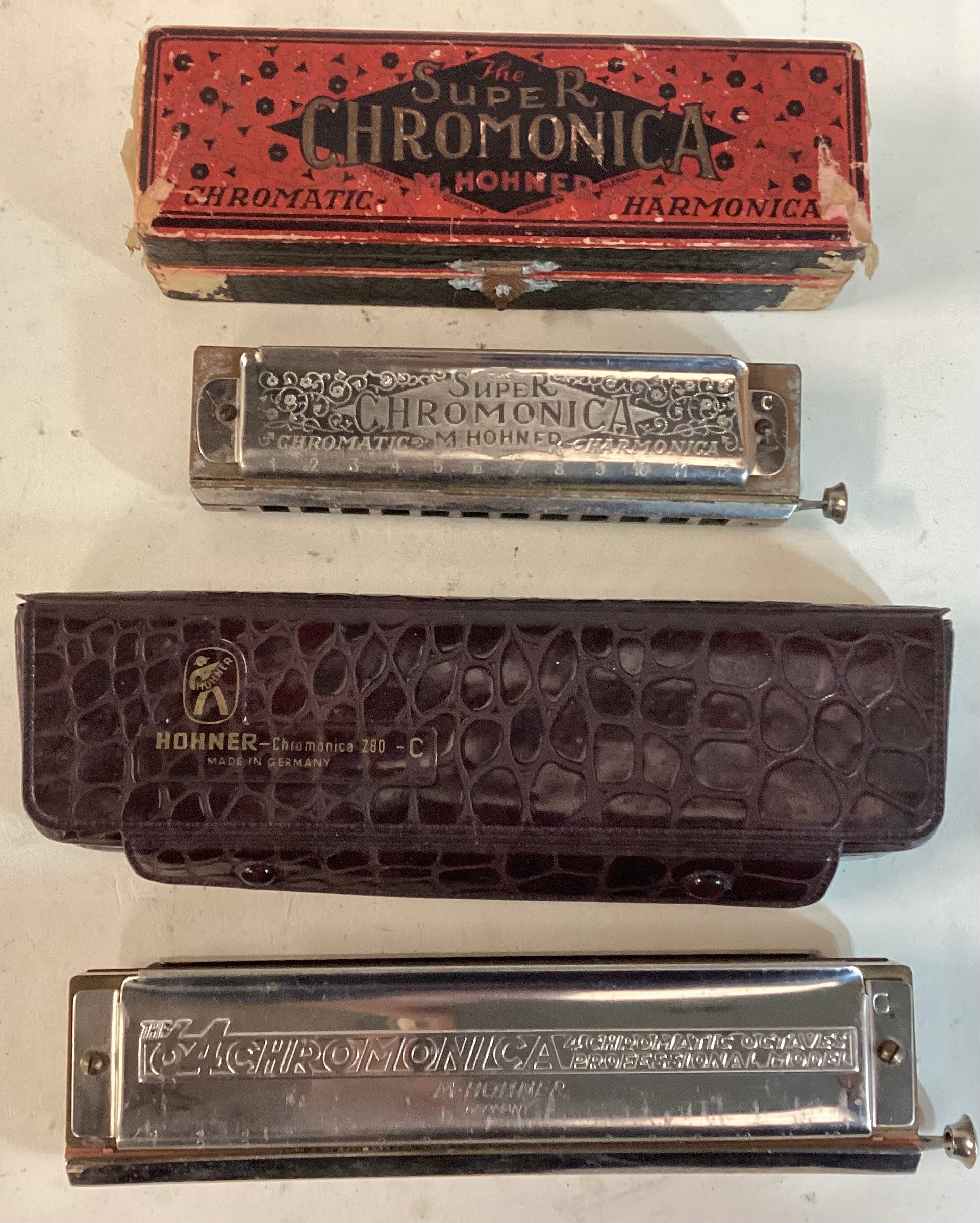 HOHNER HARMONICA’S X 2. Found here in their original containers we have a Professional Chromonica