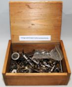 A wooden box containing a quantity of watchmakers lathe accessories etc. From a working environment