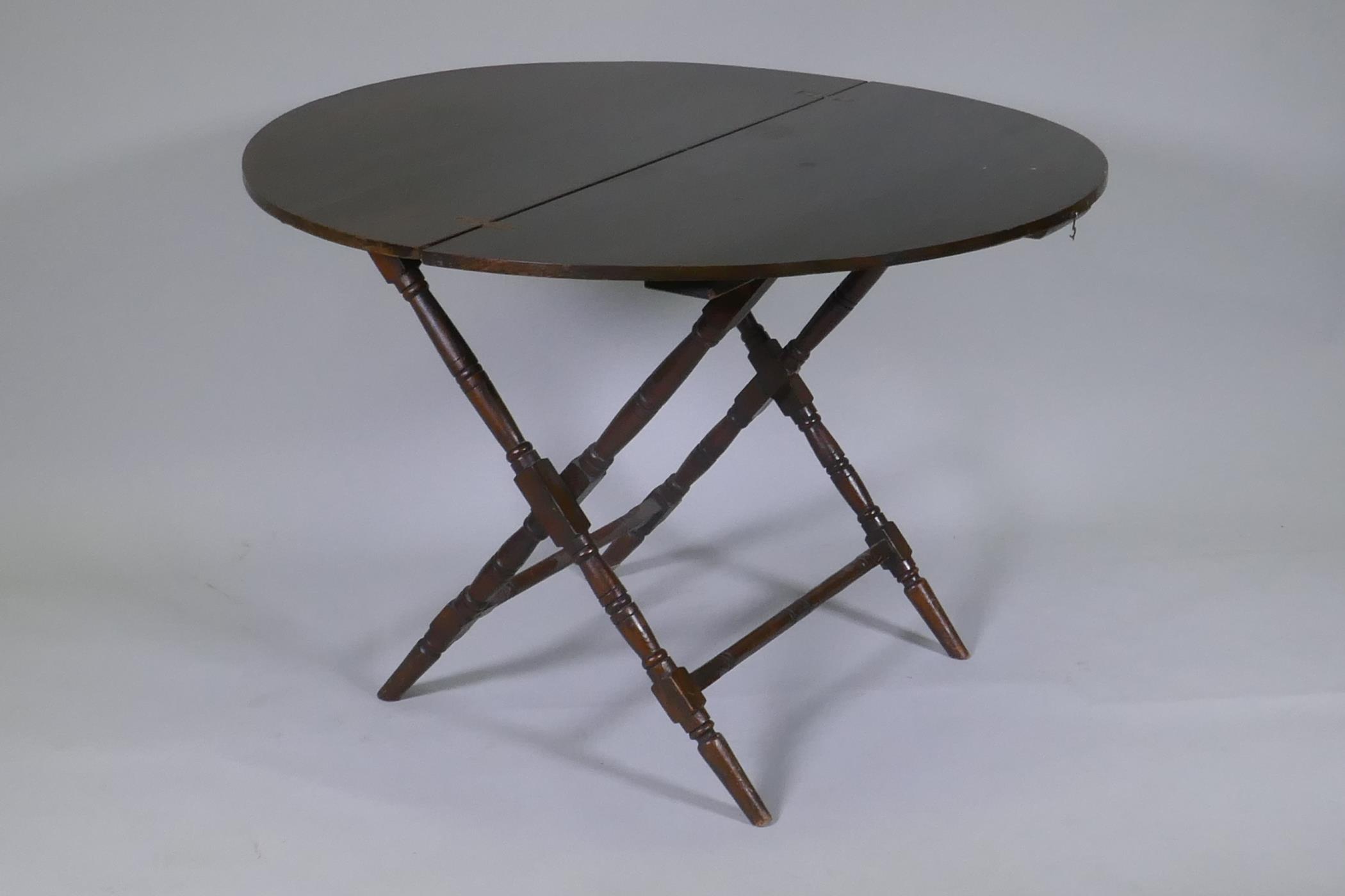 An early C20th beechwood coaching table, bears label Thornton & Herne, 13 Little Cadogan Place, Pont