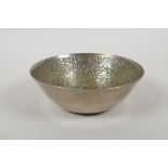 An Islamic white metal bowl, with all over script decoration, 12cm diameter, 117g