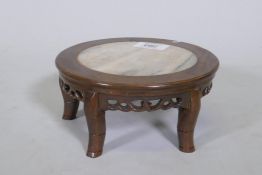 A Chinese hardwood stand with pierced frieze and inset marble top, 18cm diameter and 8cm high