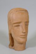 A terracotta sculpture of a female head, inscribed monogram to base, 28cm high