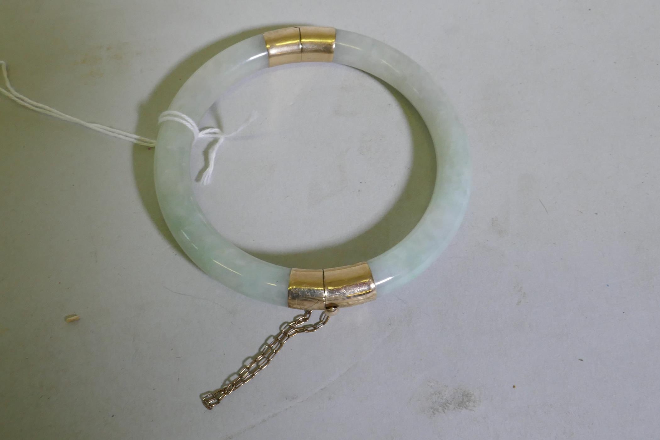 A jade bangle with 9ct gold mounts, 5.5cm internal diameter - Image 2 of 2