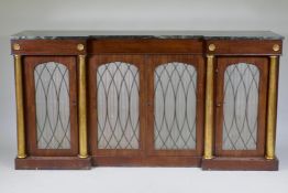 A Regency mahogany inverted breakfront side cabinet, with vert de mer marble top, three drawers over