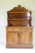 A C19th mahogany chiffonier, the upper section with two shelves, with carved supports