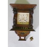 A late C19th/early C20th Black Forest wall clock, the Junghans movement striking on a gong, case AF,