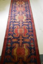 A fine woven Iranian runner, with bespoke medallion design on a rich blue field, 90 x 305cm