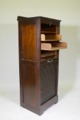 An early C20th oak tambour fronted music cabinet/filing cabinet, by Wolfe & Hollander Ltd of London,