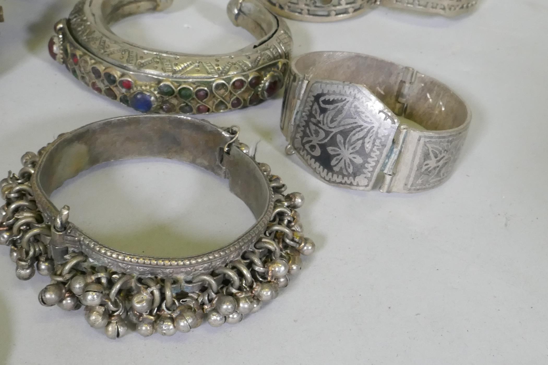 A collection of Afghan white metal bangles, set with paste stones, bidri style decoration, a Chinese - Image 6 of 6