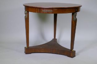 A late C19th Empire style French mahogany gueridon with brass mounts raised on tapering supports