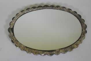 A Turkish silver framed mirror with repousse decoration and gilt highlights, stamped 900 Ohran