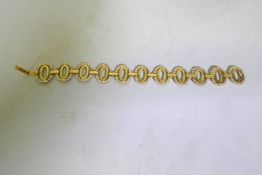 An 18ct Arab gold link bracelet set with white crystals, 18cm long