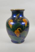 An oriental iridescent blue glazed ceramic vase decorated with lilies, character mark to base,