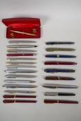 A large collection of vintage fountain pens, propelling pencils and ballpoint pens, including a