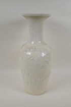 A C19th Chinese blanc de chine porcelain vase, with raised decoration of deer and crane in a