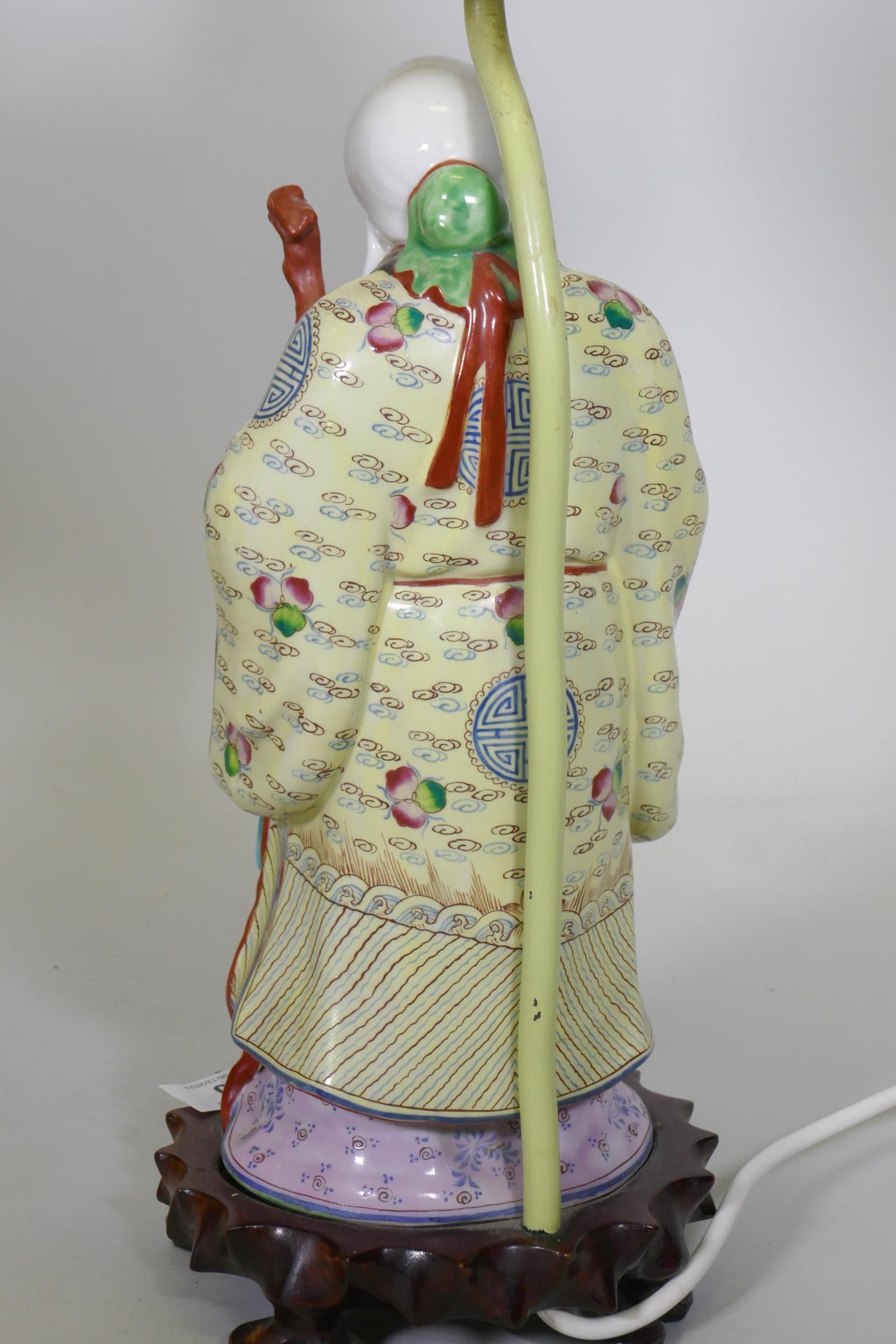 A Chinese porcelain table lamp in the form of Shao Lao holding a peach and staff with dragon's head, - Image 3 of 4