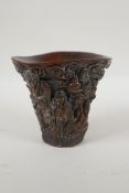 A Chinese faux horn libation cup with carved decoration of the Eight Immortals, 4 character mark