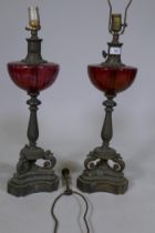 A pair of vintage table lamps with glass bowls raised on brass columns with seahorse supports,