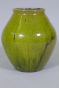 Dora Lunn, a Ravenscourt pottery vase of baluster form with mottled drip green glaze, 28cm high