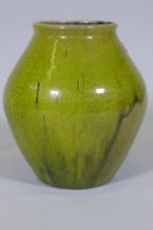 Dora Lunn, a Ravenscourt pottery vase of baluster form with mottled drip green glaze, 28cm high