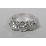 A platinum set three brilliant cut diamond ring, the central stone approx 0.95ct, flanking two
