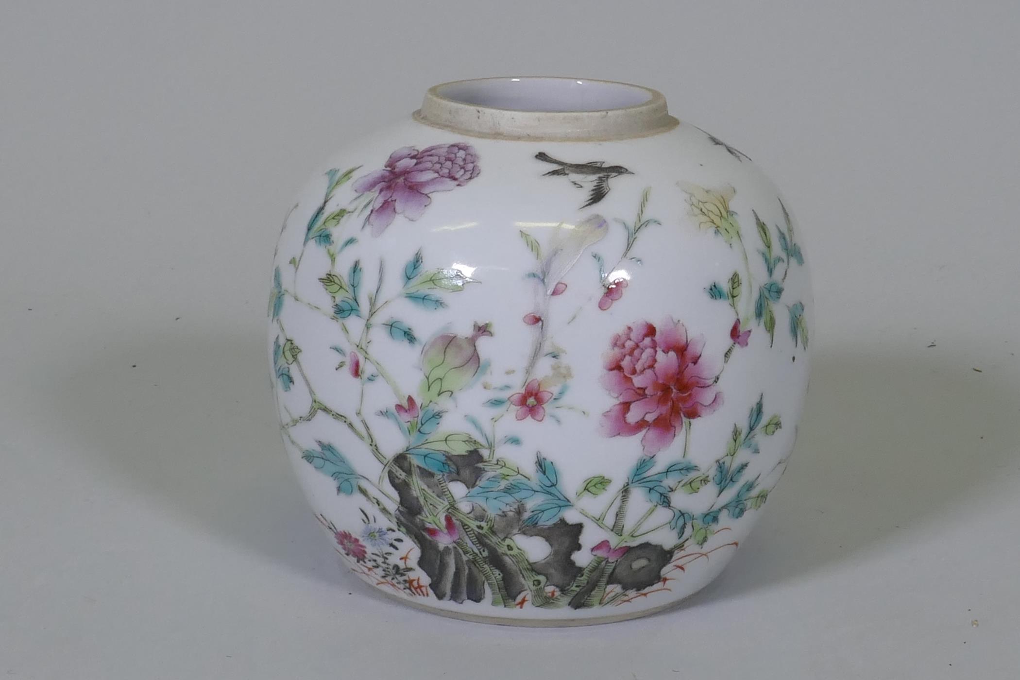 An antique Chinese famille verte storage jar, with enamel painted decoration of a rock garden, and