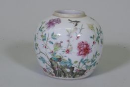 An antique Chinese famille verte storage jar, with enamel painted decoration of a rock garden, and