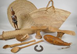A quantity of Kenyan tribal items to include carved wood head rests, gourd flask, woven baskets etc