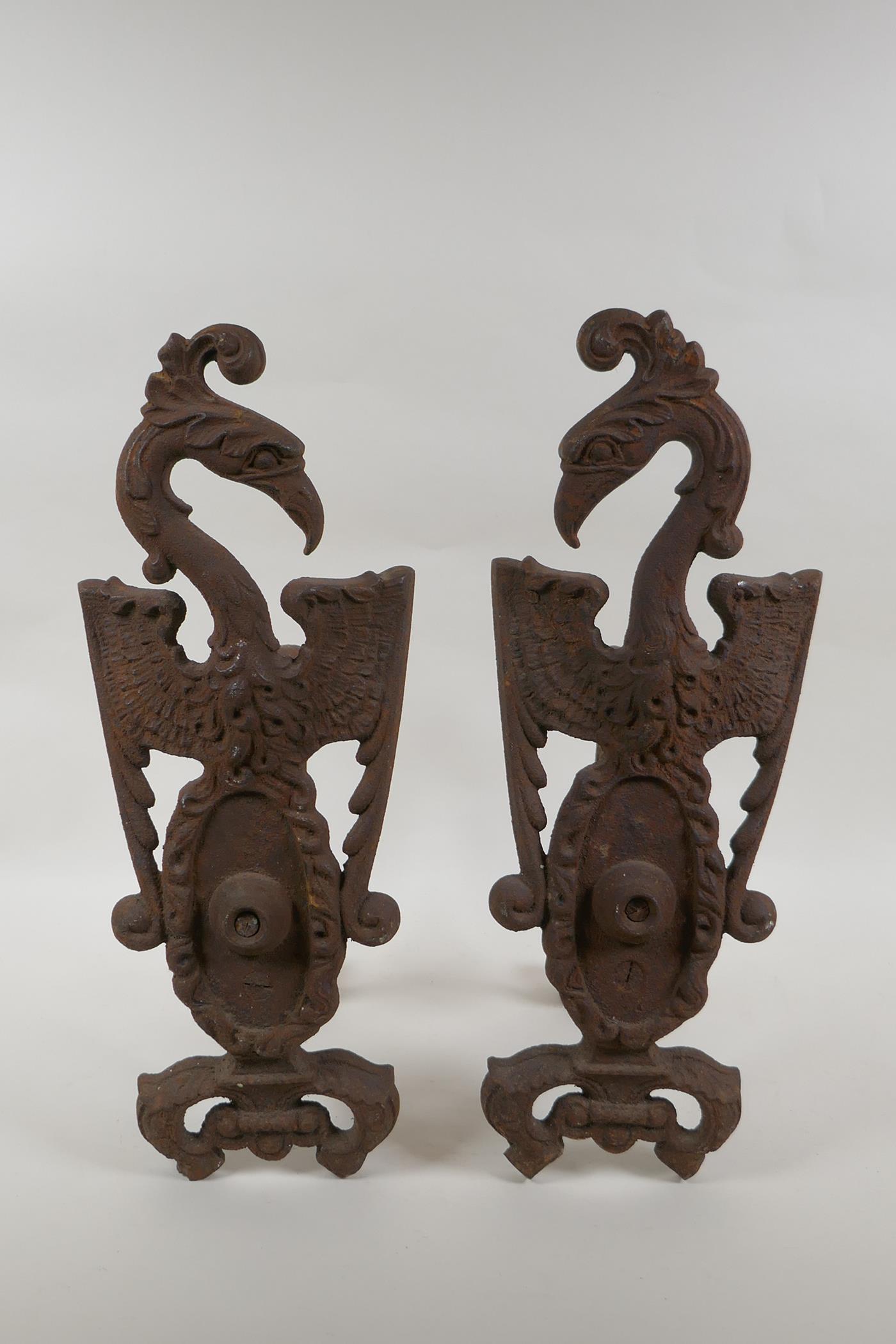 A pair of antique cast iron fire andirons in the form of phoenix, 40cm high