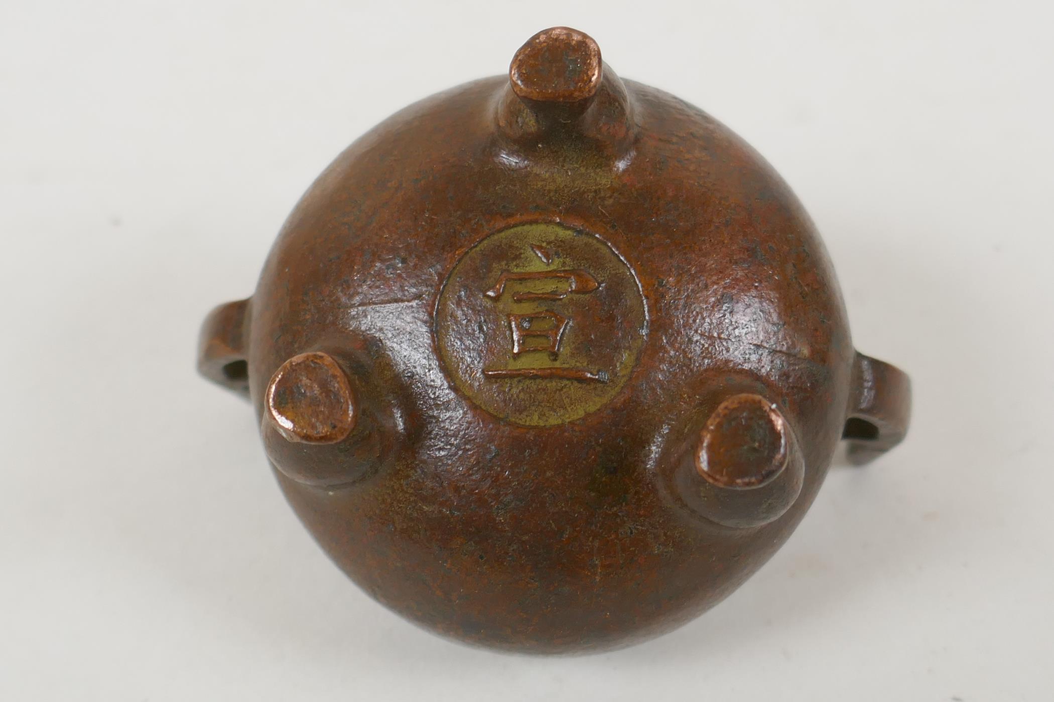 A Chinese bronze two handled censer raised on tripod supports, Xuan character mark to base, 5cm - Image 4 of 4
