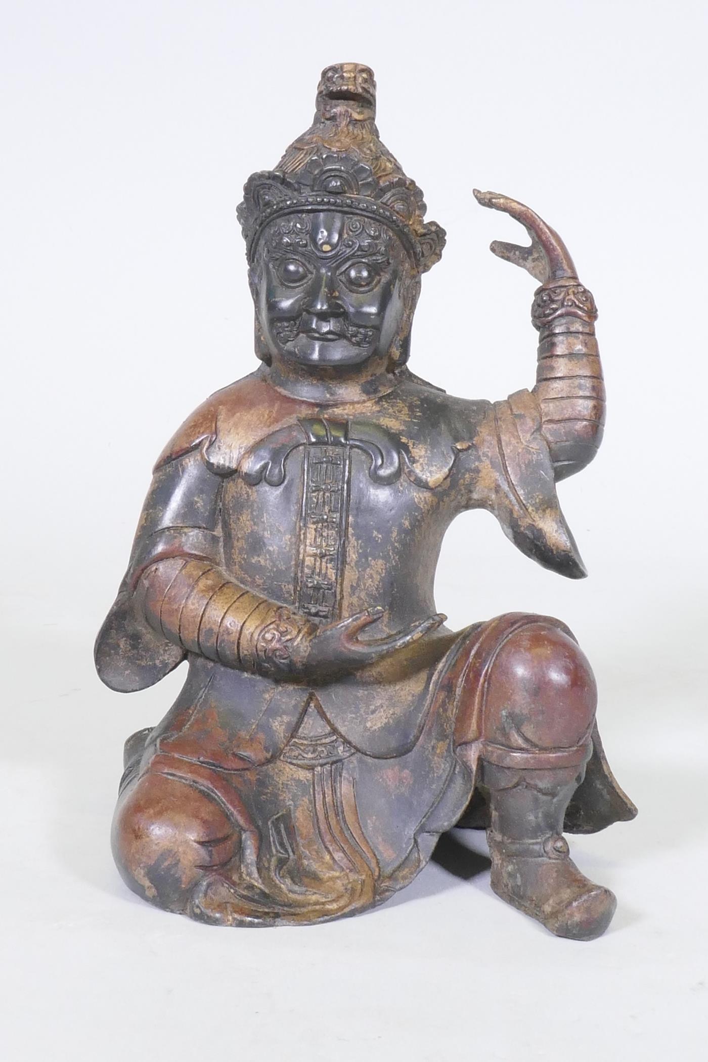 A Chinese bronze figure of an immortal, with red and gilt patination, impressed seal mark to base,