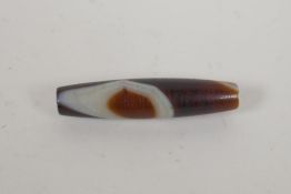 A vintage banded agate dzi bead, 6cm long