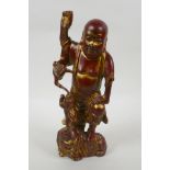 A Chinese gilt and copper lacquered bronze figure of Lohan