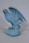 A metal figure of an eagle with verdigris patination, 45cm high