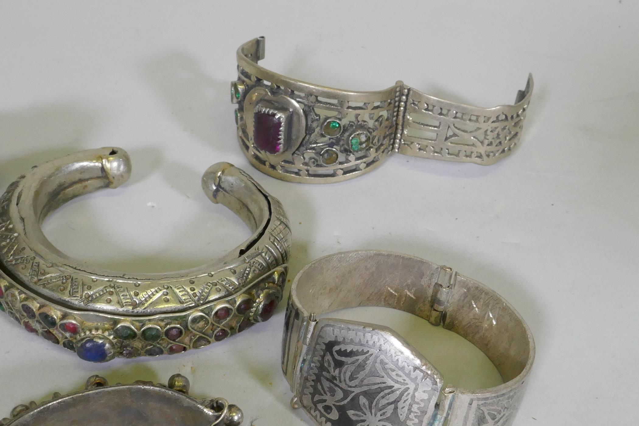 A collection of Afghan white metal bangles, set with paste stones, bidri style decoration, a Chinese - Image 2 of 6