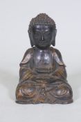 An oriental painted and gilt brass figure of Buddha, 22cm high
