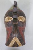 An African tribal carved and painted wood mask in the form of a cockerel, 36cm long