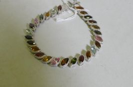 Hallmarked silver bracelet set with coloured gemstones, 20cm long