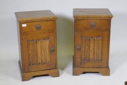 A pair of 'Maple' oak bedside chests, with single drawer over a cupboard, with linen fold panel,