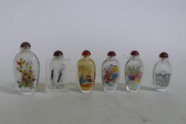 Six Chinese reverse decorated glass snuff bottles, largest 10cm high
