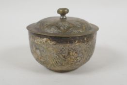 An Islamic white metal bowl, with all over script decoration, 8cm diameter, 98g