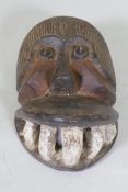 An African tribal carved and painted wood mask in the form of a monkey, 30cm long