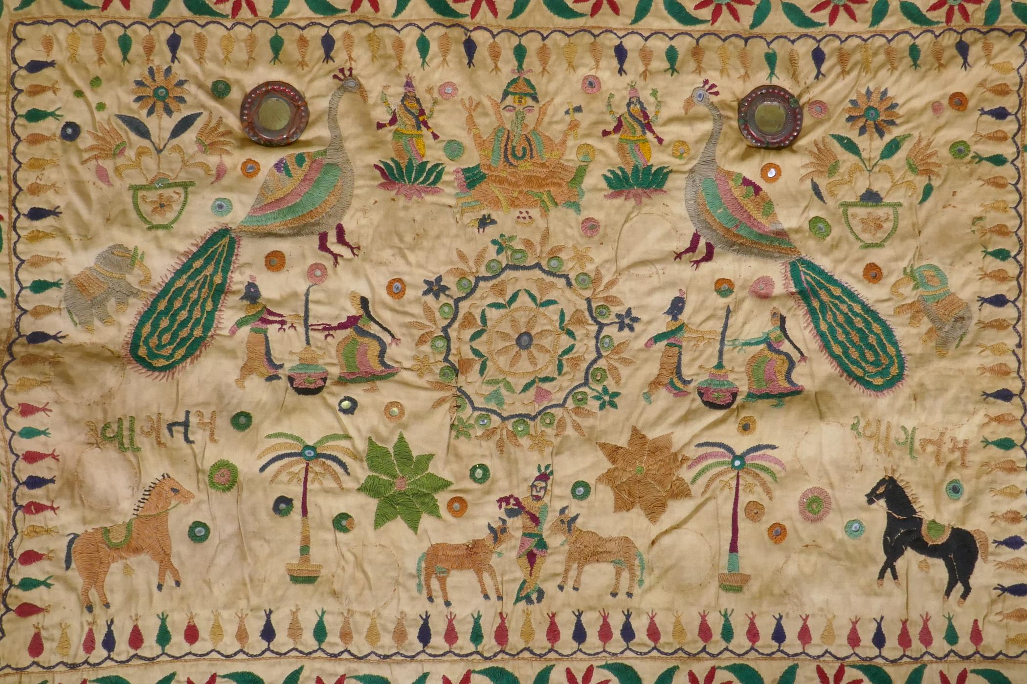 A C19th Indian embroidered wall hanging decorated with depictions of Ganesh, peacocks, elephants, - Image 2 of 9