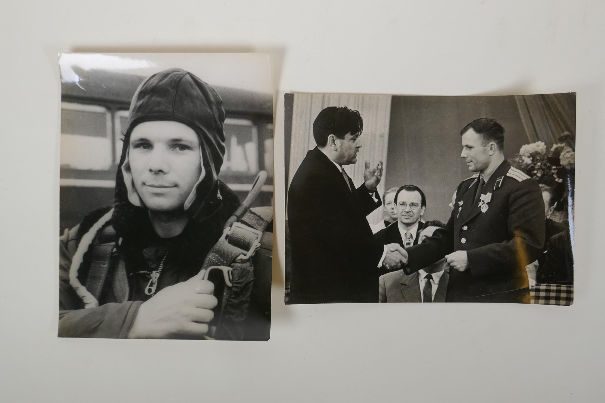 Two vintage press photos of Yuri Gagarin, with archival stamps and typed Cyrillic descriptions
