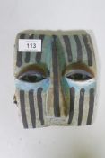 A glazed ceramic mask plaque, early/mid C20th, 16cm long