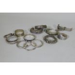 A collection of Afghan white metal bangles, set with paste stones, bidri style decoration, a Chinese