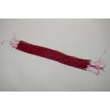 Nine bead strings of faceted ruby coloured hardstone, assorted sized strands, 39cm long