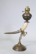 Antique oil lamp with horn body and brass mounts and reservoir, 60cm high